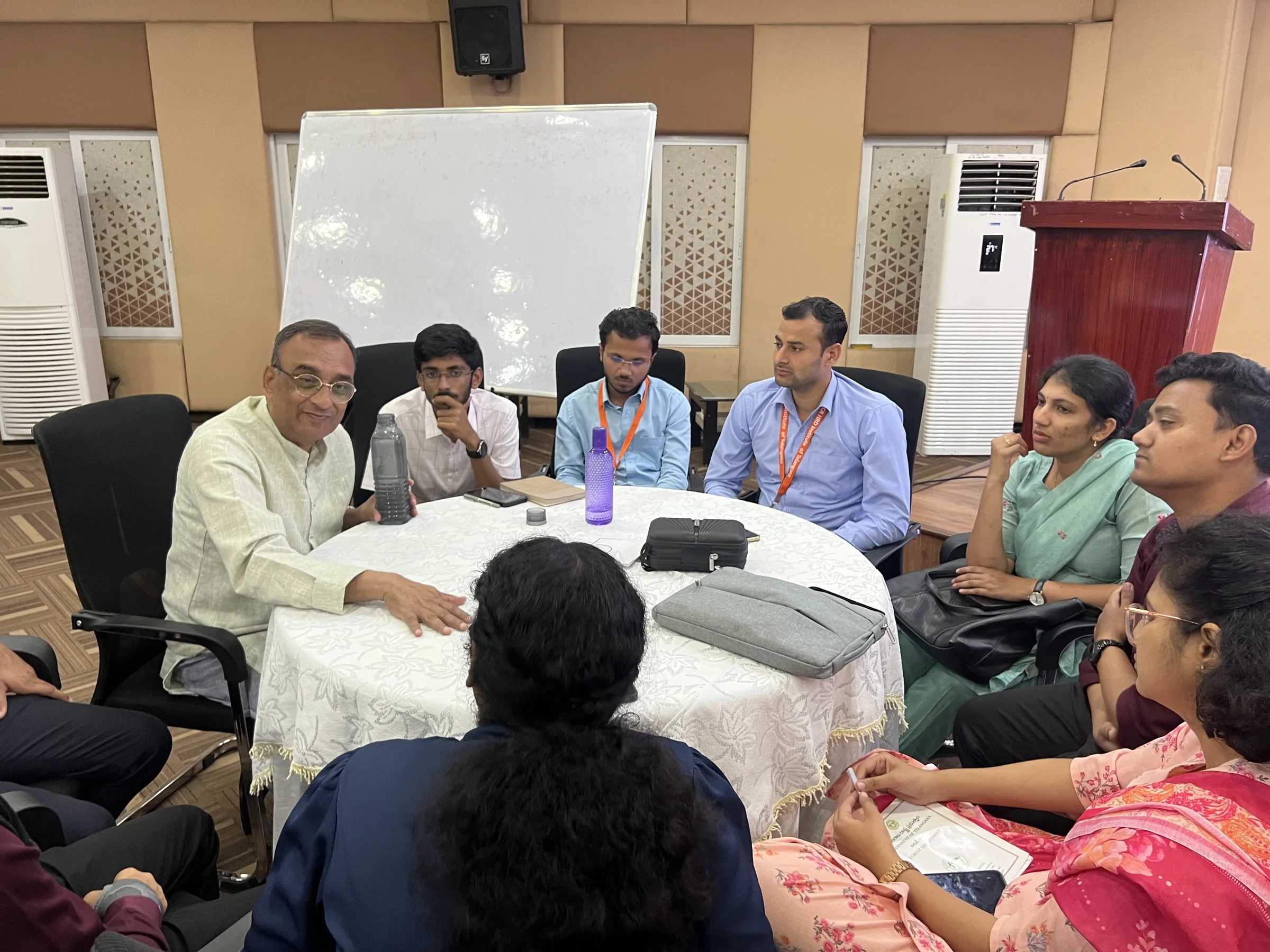 Participants gather closely around a table during a Living Stories session.
