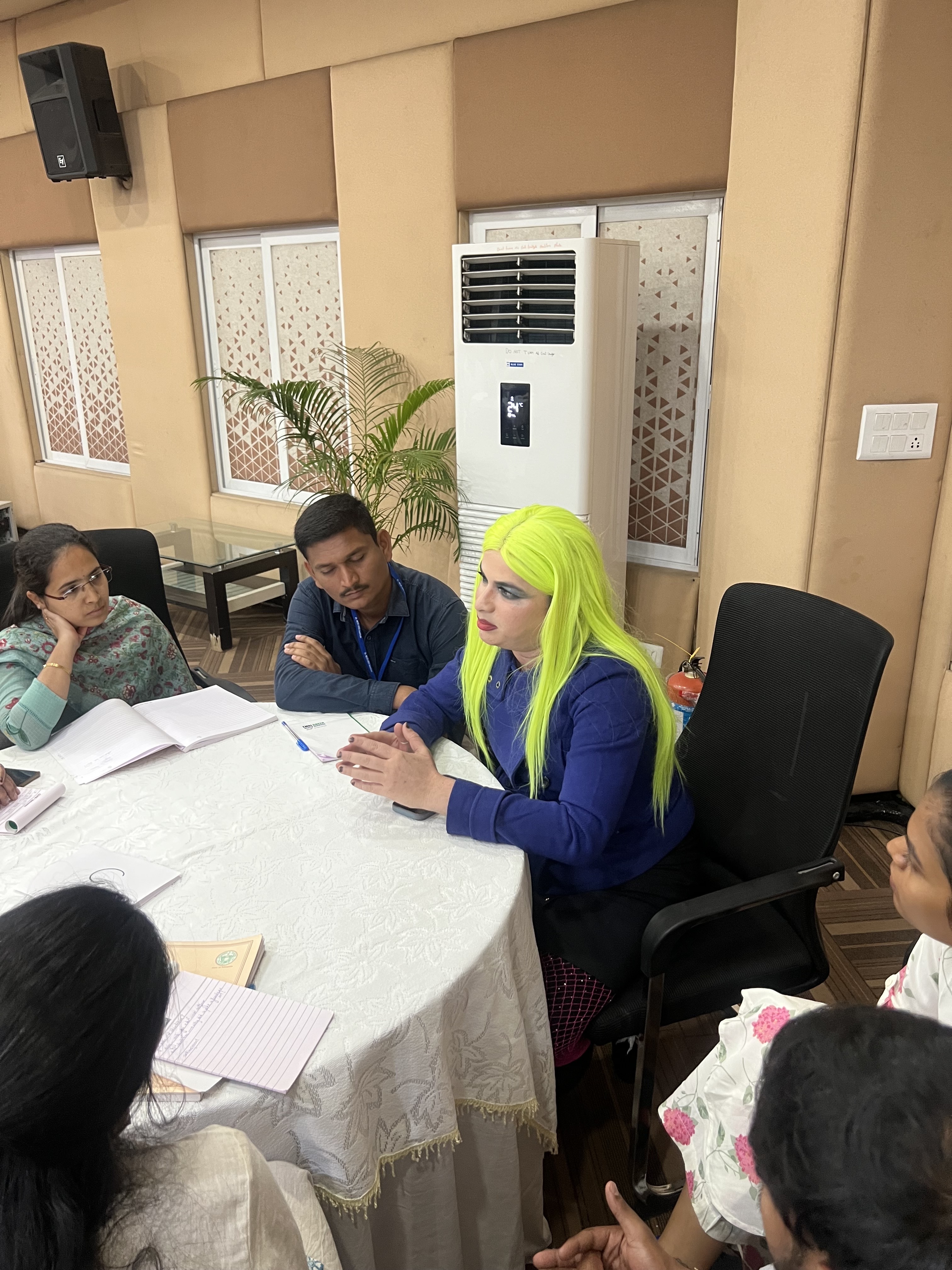 Participants seated around a table during a Living Stories Collective conversation circle.